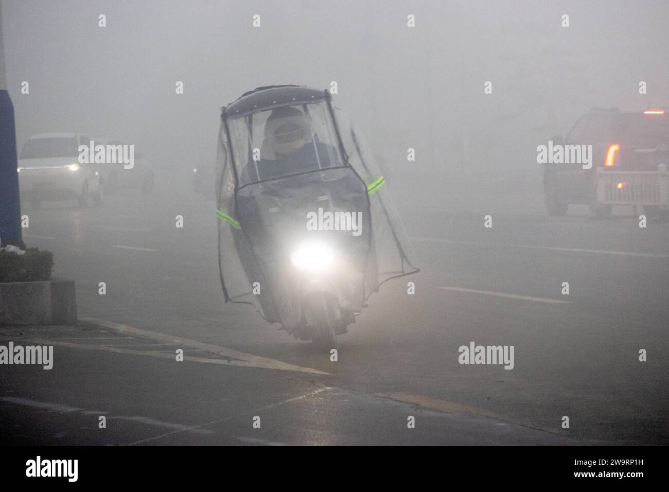 ANYANG, CINA - 30 DICEMBRE 2023 - le persone viaggiano nella nebbia pesante con visibilità inferiore a 200 metri nella contea di Hua, nella città di Anyang, provincia di Henan, chi Foto Stock