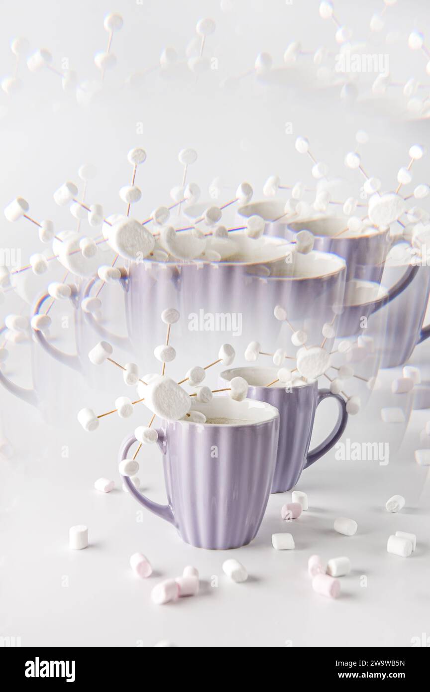 Tazze viola con caffè caldo e marshmallow. Due tazze con marshmallow a fiocco di neve. Effetto caleidoscopio. Foto Stock