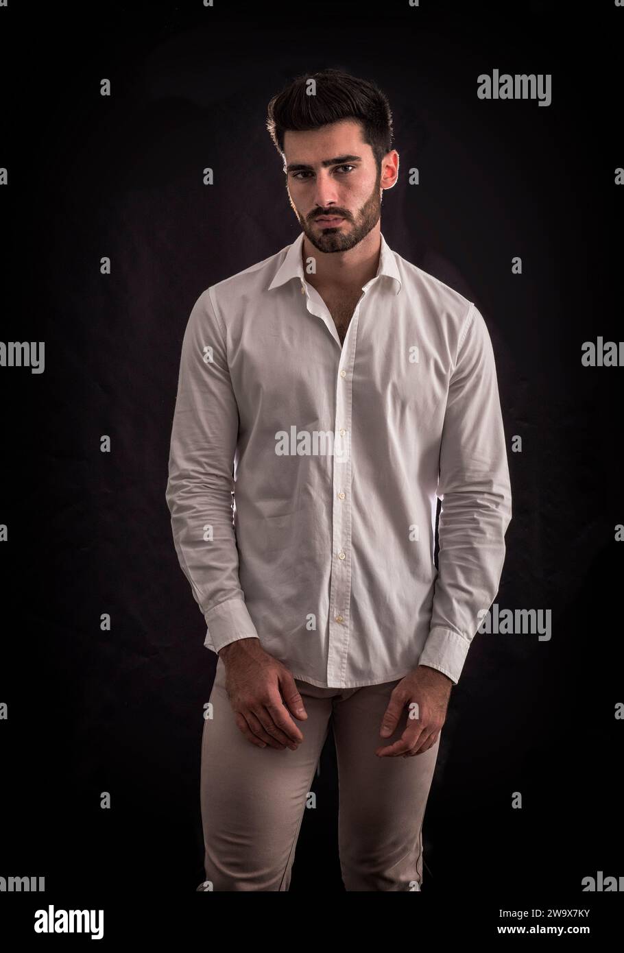 Un uomo con una camicia bianca e pantaloni abbronzanti Foto Stock