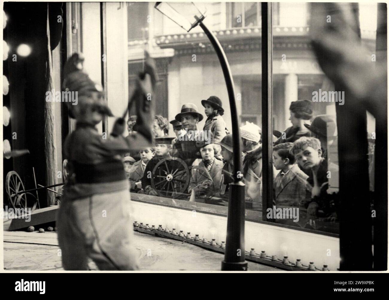 1934 c., Parigi , FRANCIA : gruppi familiari con bambini, davanti ad una vetrina di un negozio di giocattoli (con marionette meccaniche di pompieri in movimento ), sotto il periodo natalizio , sognando i regali di Babbo Natale . L' inaugurazione di queste finestre speciali , in dicembre , segnò tradizionalmente l' inizio del periodo natalizio . Foto di Agencie Meurisse , fotografo sconosciuto . - NATALE - GIOCO - GIOIA - GIOIA - SORPRESA - SORPRESA - STUPORE - STUPORE - FANTASTICI - GIOCATTOLI MECCANICI IN MOVIMENTO - VETRINA DI UN NEGOZIO - NATALE - IMMAGINE NATALIZIA - FOTO STORICHE - STORIA - BAMBINO - BAMBINI Foto Stock