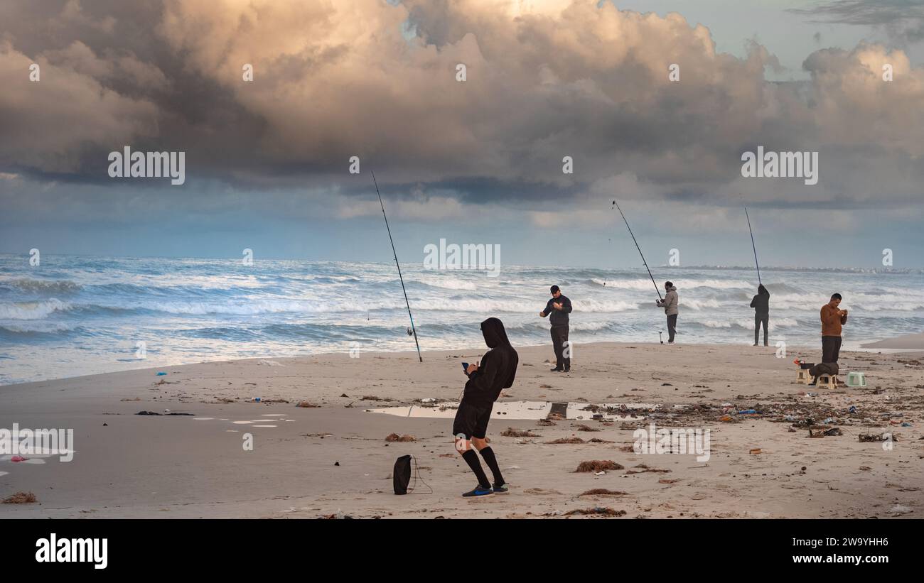 La gente pesca al crepuscolo sulla spiaggia di Bou Jaafar sul Mar Mediterraneo a Sousse, Tunisia. Foto Stock