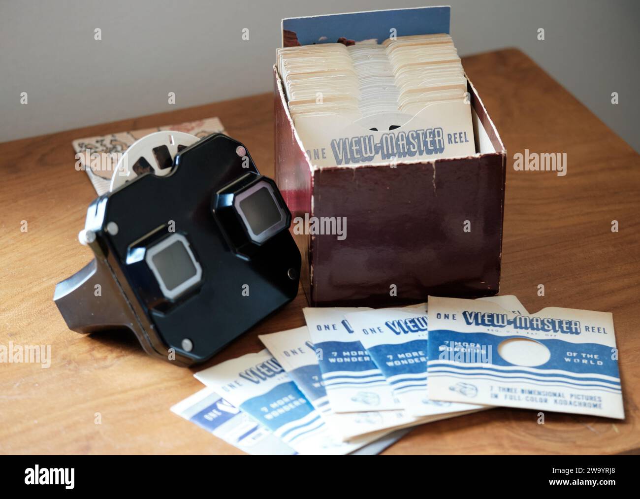 Viewmaster nero vintage con una scatola di altre meraviglie del mondo, rulli e scivoli. Foto Stock