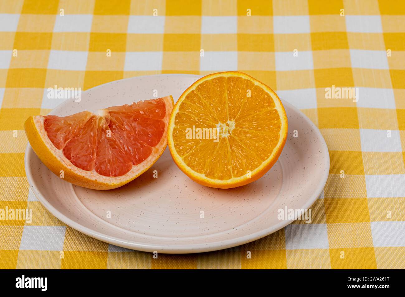 Arancia a fette e pompelmo su piatto. Frutta biologica, dieta sana e concetto nutrizionale. Foto Stock