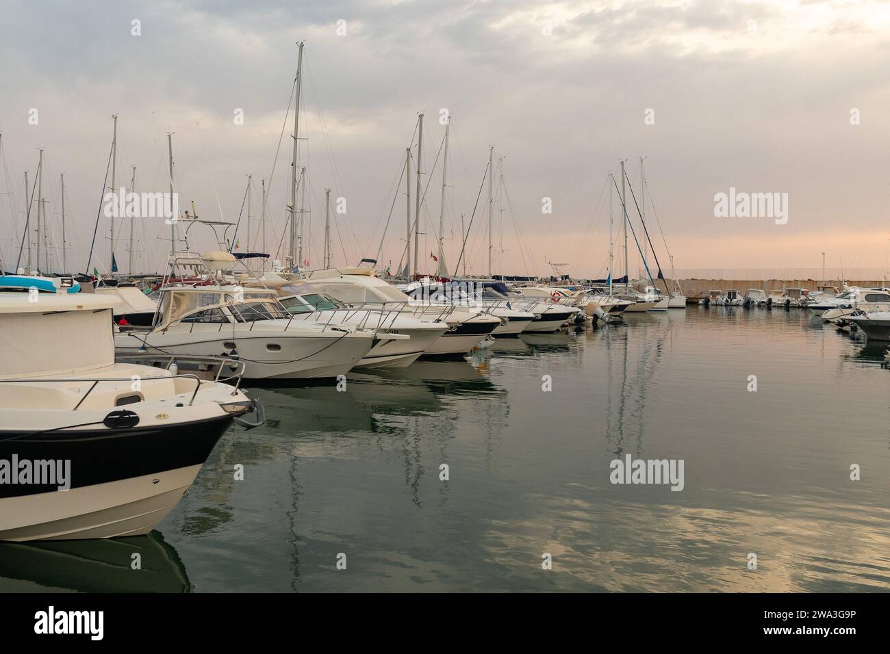 Vista del porto turistico sulla Costa degli Etruschi con barche a vela ormeggiate e yacht al tramonto, San Vincenzo, Livorno, Toscana, Italia Foto Stock