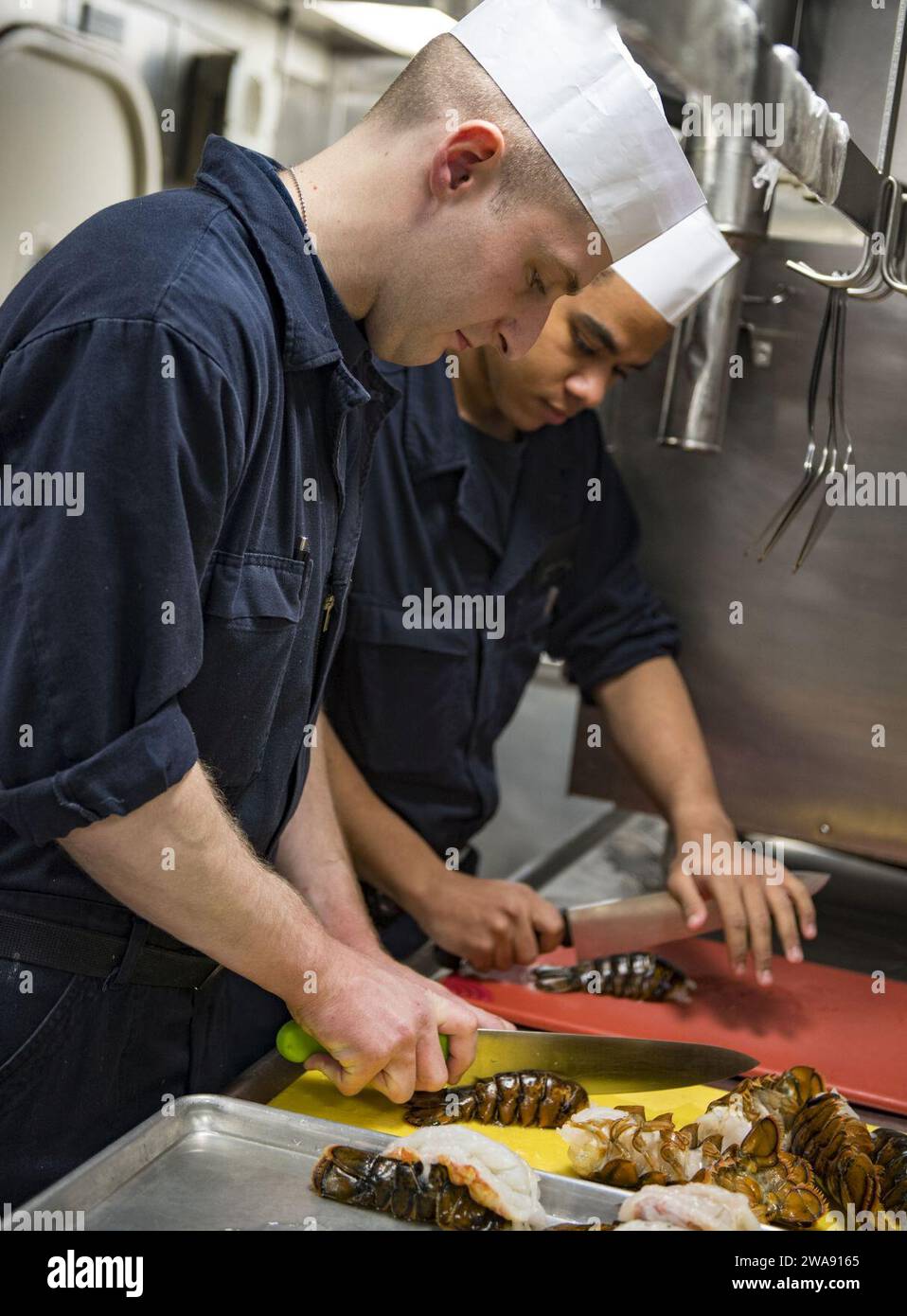 Forze militari STATUNITENSI. 180225RG482-244 MAR NERO (25 febbraio 2018) Specialista culinario Seaman Mitchell Schwinn Trains Culinary Specialist Seaman Hunter Moore come preparare l'aragosta a bordo del cacciatorpediniere guidato-missile classe Arleigh Burke USS Ross (DDG 71), nel Mar Nero 25 febbraio 2018. Ross, schierato in avanti a Rota, in Spagna, è nella sua sesta pattuglia nell'area operativa della 6th Fleet degli Stati Uniti a sostegno degli alleati regionali e dei partner e degli interessi di sicurezza nazionale degli Stati Uniti in Europa. (Foto della Marina degli Stati Uniti di Mass Communication Specialist 1st Class Kyle Steckler/rilasciata) Foto Stock