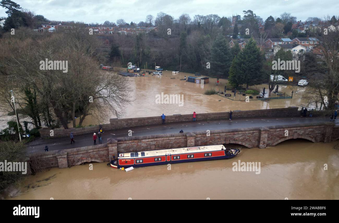 Barrow Upon Soar, Leicestershire, Regno Unito. 3 gennaio 2024. Meteo del Regno Unito. Una barca stretta è intrappolata contro un ponte dopo essersi liberata dal suo ormeggio sul fiume Soar. La pioggia battente ha colpito un'ampia zona del Regno Unito con la piccola ma potente tempesta Henk. Credit Darren Staples/Alamy Live News. Foto Stock