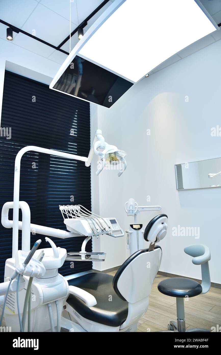 Studio dentistico con sedia e attrezzature. Concetto di odontoiatria e assistenza sanitaria. Foto Stock