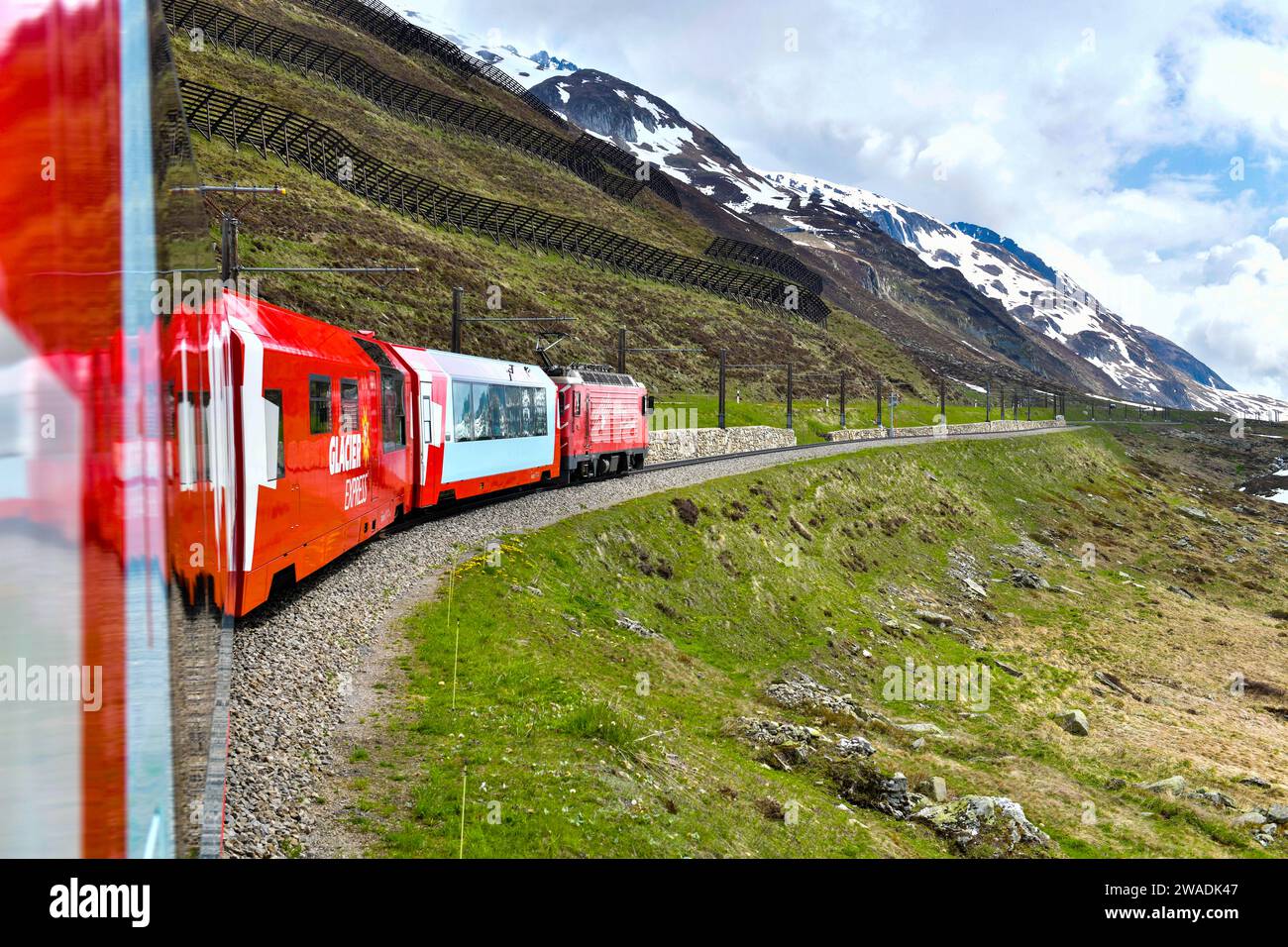 Zermatt 24.5,2023: Treno svizzero rosso Glacier Express nelle Alpi svizzere. Zermatt per St.Moritz. La Svizzera d'estate Foto Stock