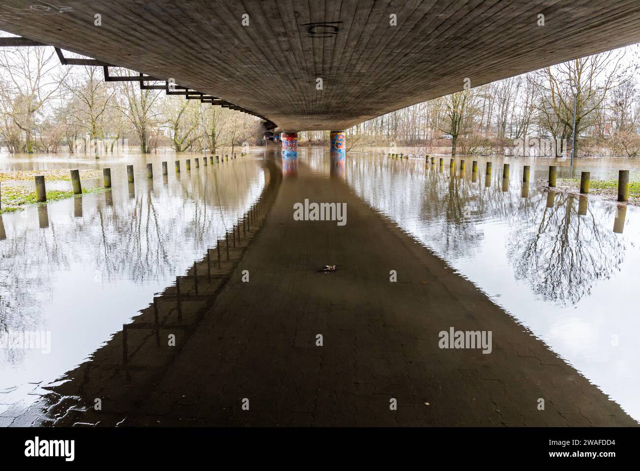 4 gennaio 2024, Assia, Gießen: Il Lahn ha fatto esplodere le sue banche. Il sentiero pedonale e la pista ciclabile (in primo piano) sotto il ponte Konrad Adenauer sono già allagati. Foto: Christian Lademann/dpa Foto Stock