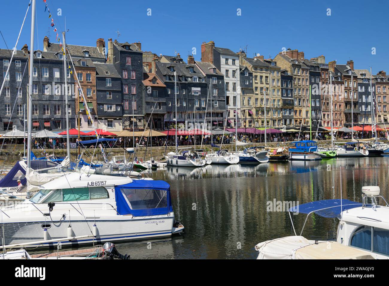 Honfleur, Francia - 24 luglio 2022: Il vecchio porto di Honfleur in una giornata di sole in estate, cielo blu Foto Stock