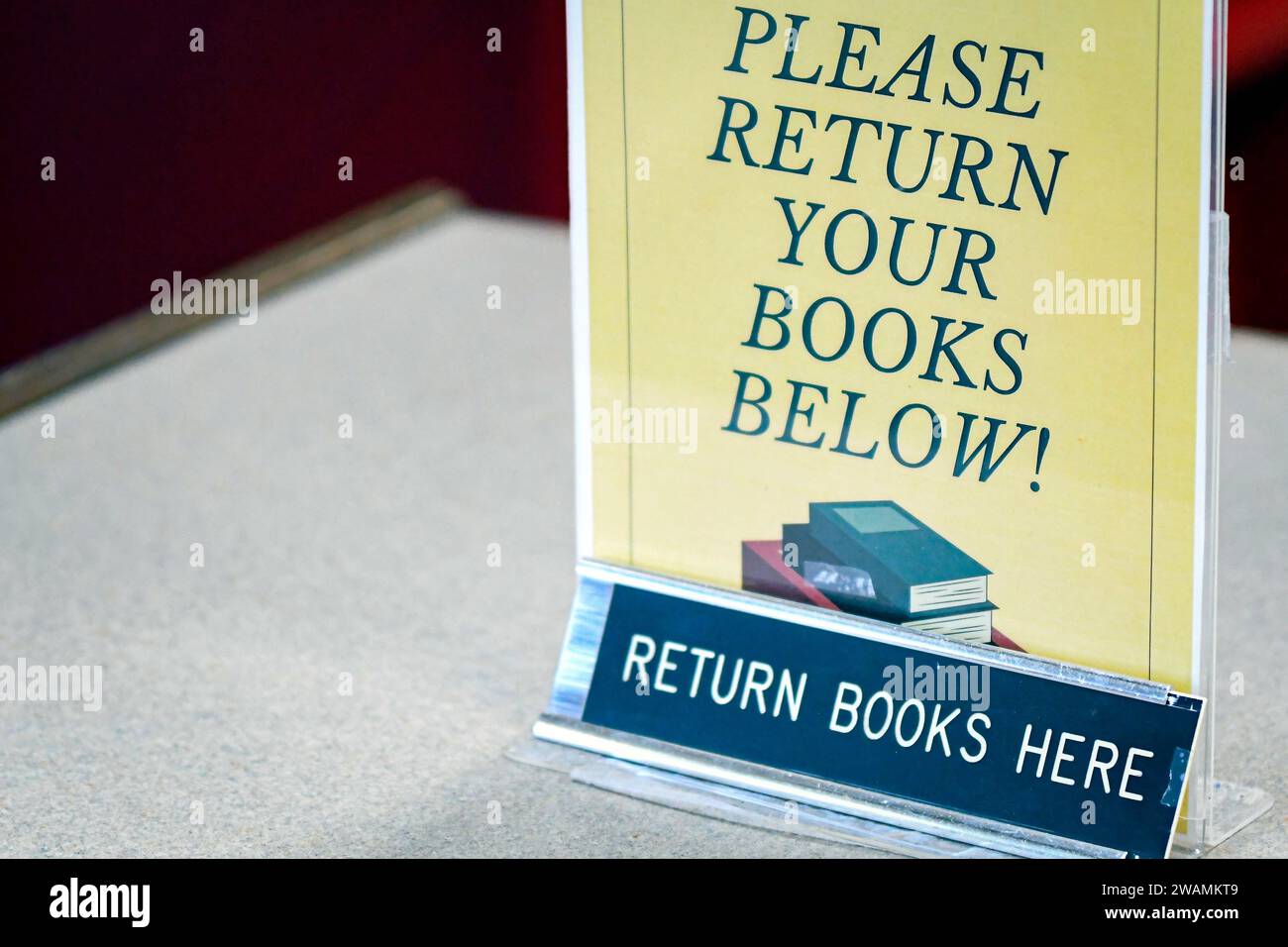 Cartello di ritorno libro in una libreria con spazio negativo a sinistra. Foto Stock