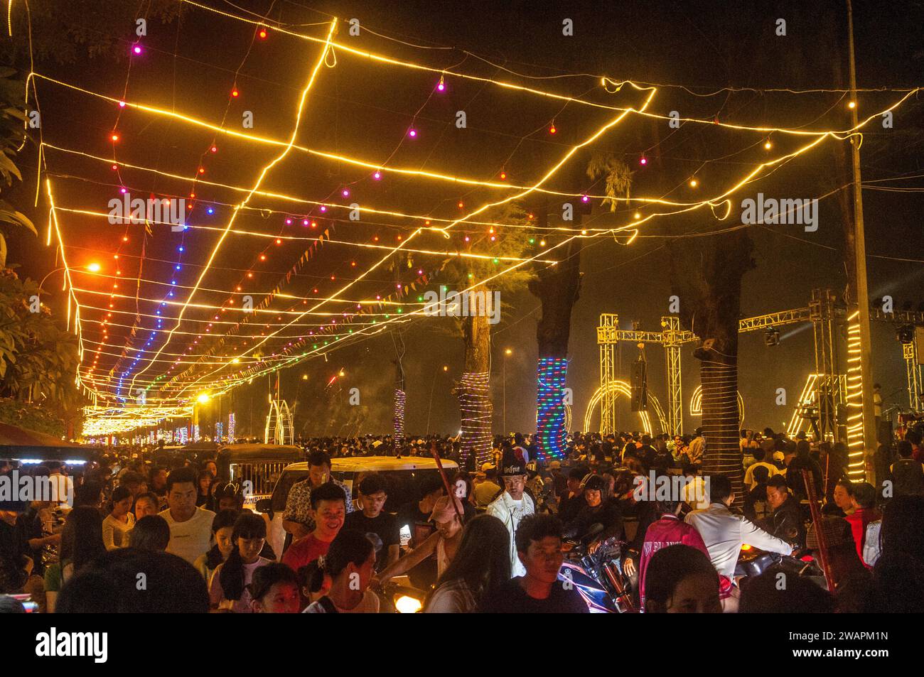 I Revelers mettono le strade vicino a un concerto sul lungofiume a mezzanotte / Capodanno 2023 - 2024. Kampot, Cambogia. © Kraig Lieb Foto Stock