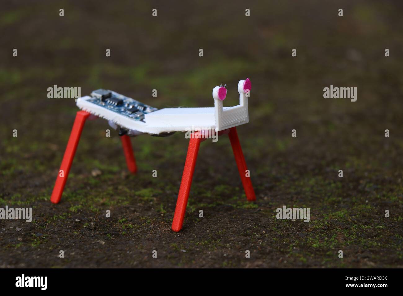 Robot semplice realizzato con parti stampate in 3d e alcuni componenti elettronici poggiati a terra Foto Stock