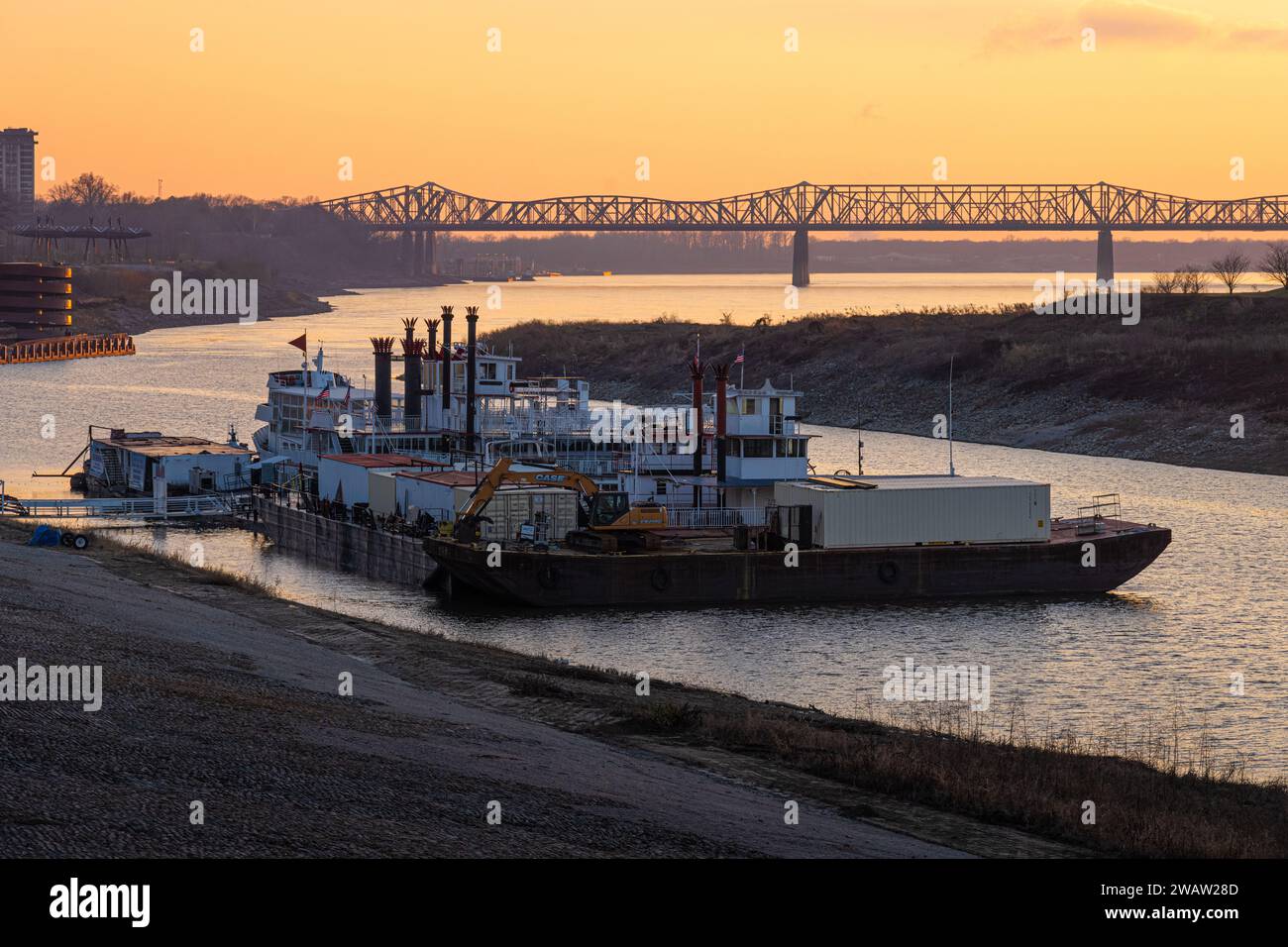 Memphis, Tennessee, battelli a vapore lungo il fiume Mississippi al tramonto vicino al ponte Memphis-Arkansas e al parallelo Harahan Bridge. (USA) Foto Stock