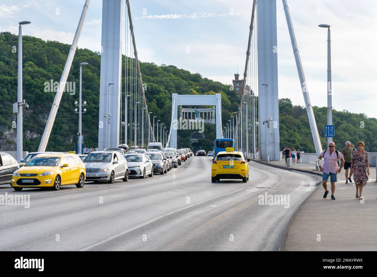 Ponte Elisabetta con traffico automobilistico e gente che cammina sul Danubio. Gellért Hill è sullo sfondo. Budapest, Ungheria. 2 agosto 2023 Foto Stock