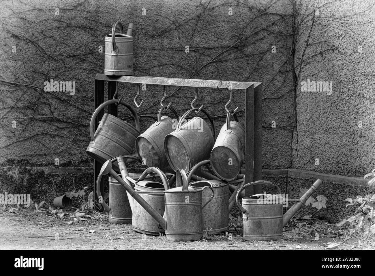 Una collezione di lattine e secchi in metallo in scala di grigi Foto Stock