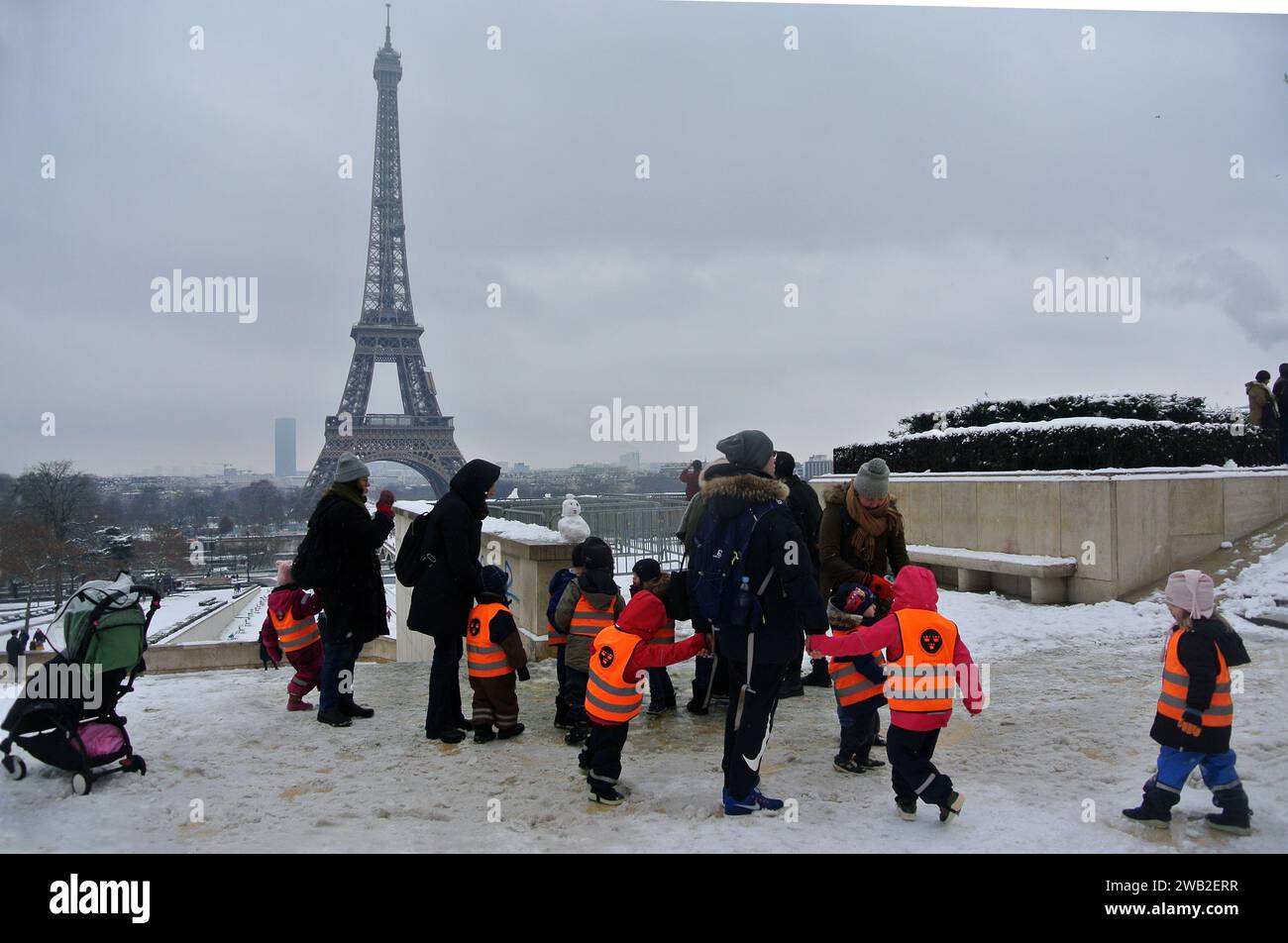 Neve inaspettata a Parigi. I bambini sono stati portati a fare una passeggiata nel giardino del Trocadero. Foto Stock