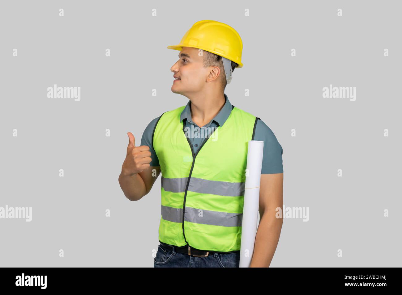 Un ingegnere asiatico Happy Construction Worker che dà espressione ai gesti con carta da lettere e notebook Foto Stock