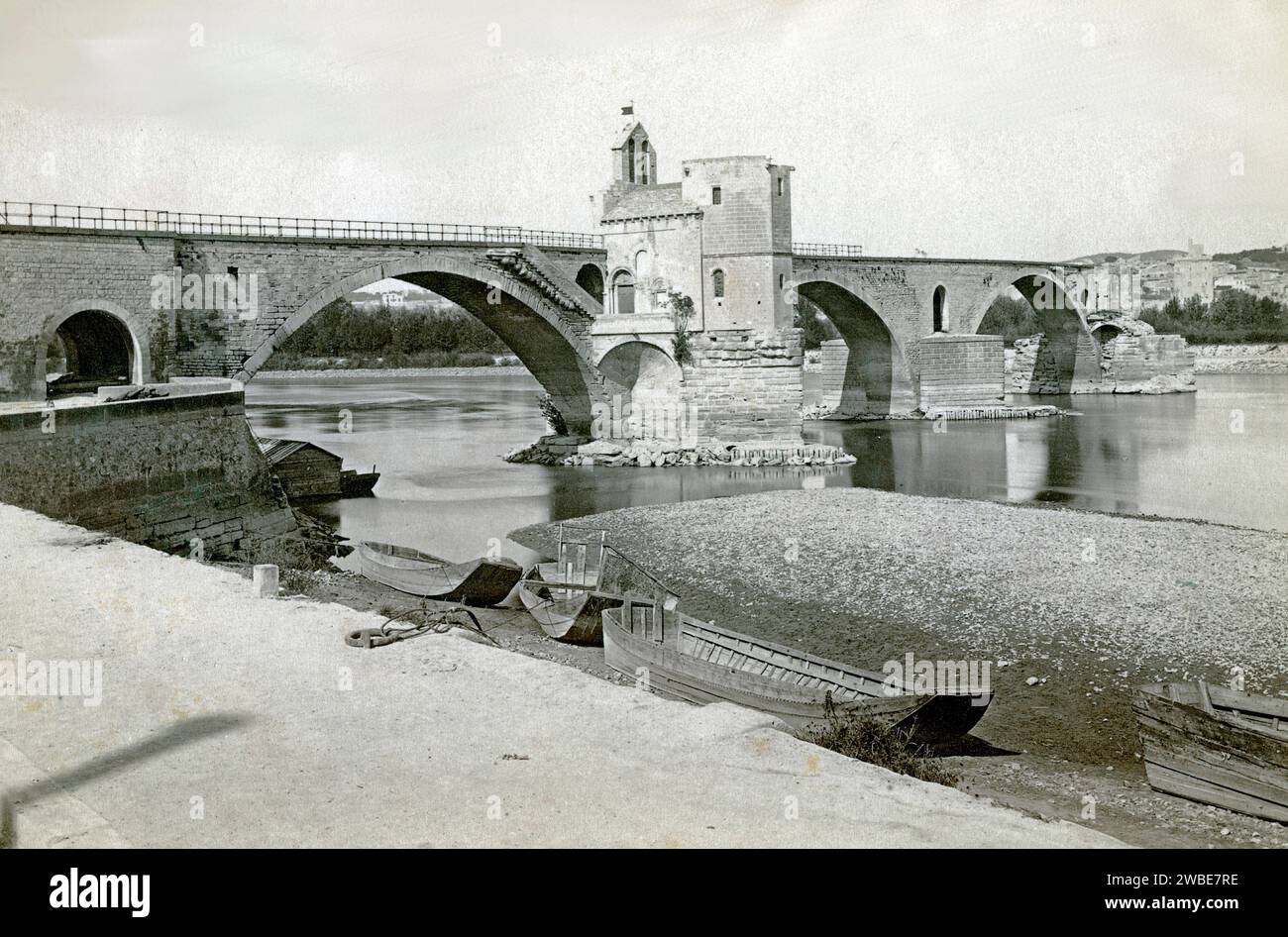 Lo storico Pont Saint-Bénézet o Pont d'Avignon Ponte sul fiume Rhône e barche a remi in legno Avignone Vaucluse France c1900. Fotografia vintage o storica in bianco e nero o monocromatica. Foto Stock