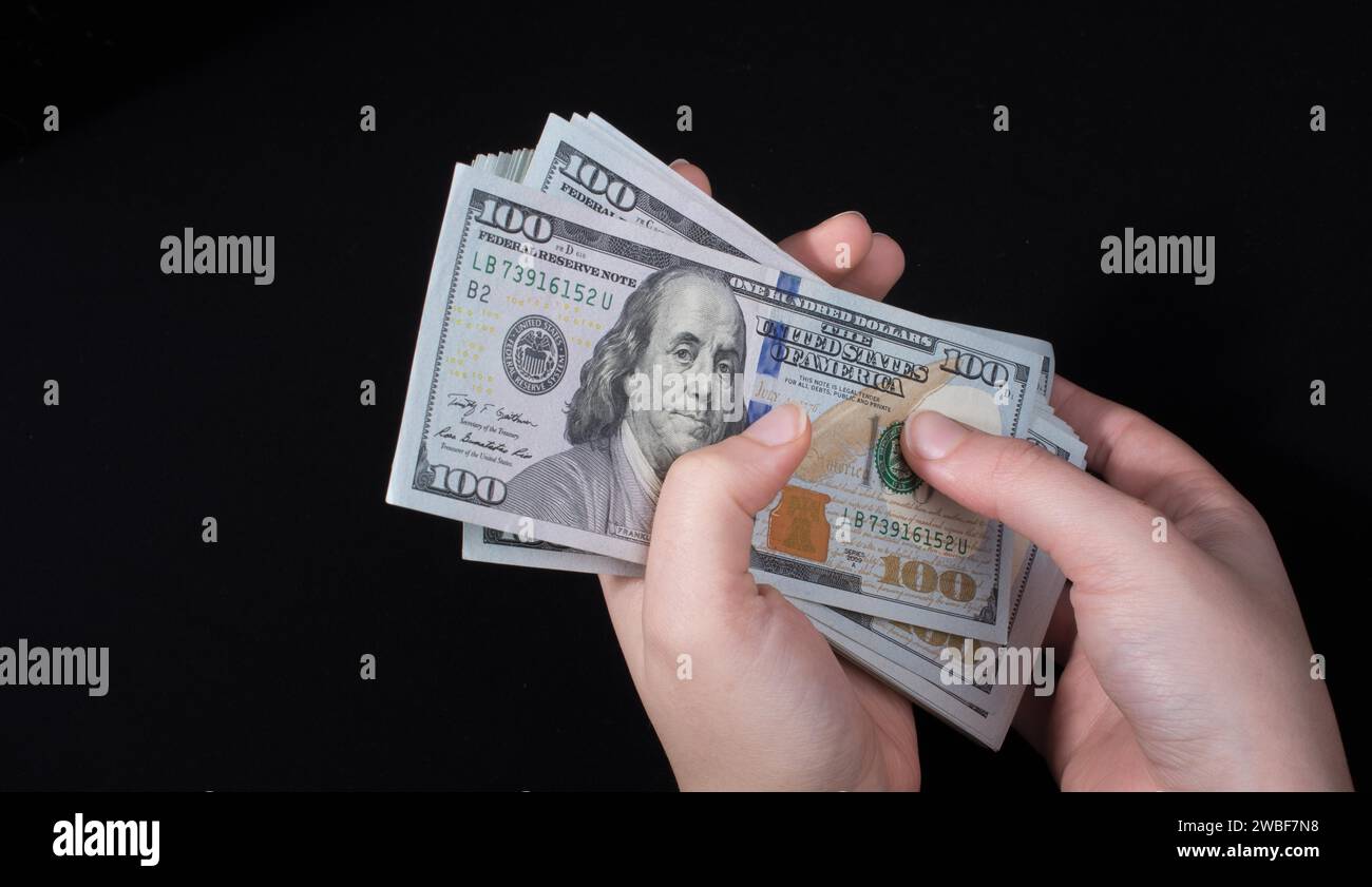 Tenere a mano le banconote in dollari americani isolate su sfondo bianco Foto Stock