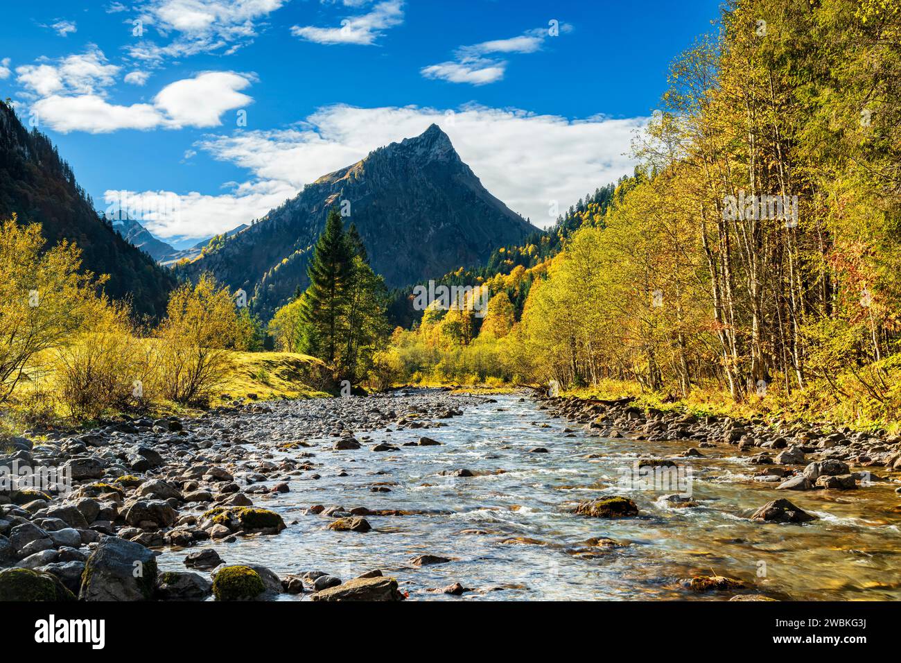 Fiume, montagne e foreste colorate in un pittoresco paesaggio montano in autunno. Ostrach nella valle dell'Hintersteiner, Alpi di Allgäu, Baviera, Germania Foto Stock