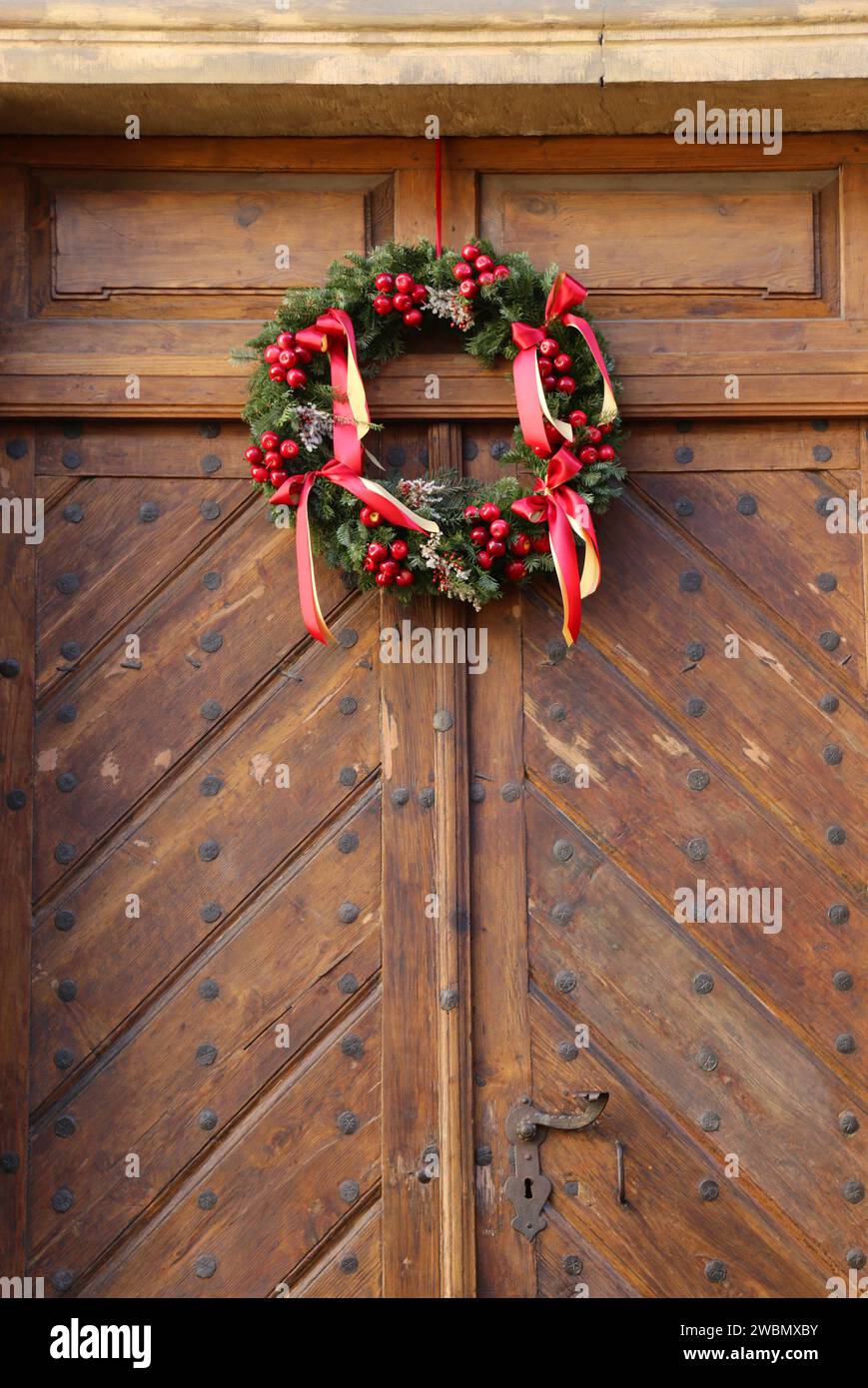 Decorazione natalizia - una corona sulla porta antica. Foto Stock