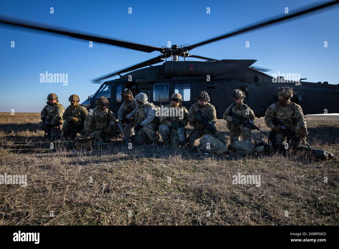 Soldati d'artiglieria della Bravo Battery 'Bone Crusher', 3rd Battalion, 320th Field Artillery Regiment, 3rd Brigade Combat Team, 101st Airborne Division, attaccati alla “Task Force 82”, conducono un assalto aereo con il 3rd Attack Helicopter Battalion, 1st Aviation Regiment, 1st Combat Aviation Brigade, 1st Infantry Division, presso Mihail Kogalniceanu Air base, Romania, 11 gennaio 2024, per aumentare la prontezza e la competenza nelle operazioni di assalto aereo. (Foto dell'esercito degli Stati Uniti di PFC. Aiden o'Marra) Foto Stock