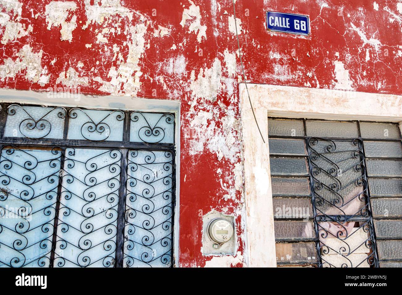 Merida Mexico, il centro storico del centro storico storico, gli edifici con vernice sbucciante, le finestre ornamentali in ferro battuto, l'insegna Calle 68, casa h Foto Stock