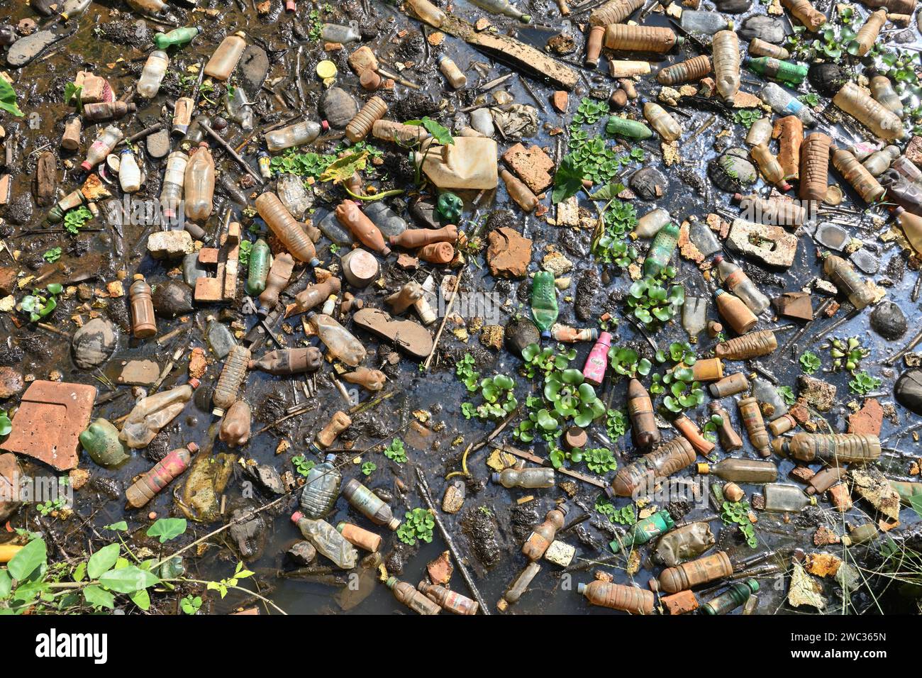 Horana, Sri Lanka - 4 gennaio 2024 - Vista dei rifiuti solidi raccolti in un flusso d'acqua bloccato. Il flusso è bloccato dai rifiuti urbani Foto Stock