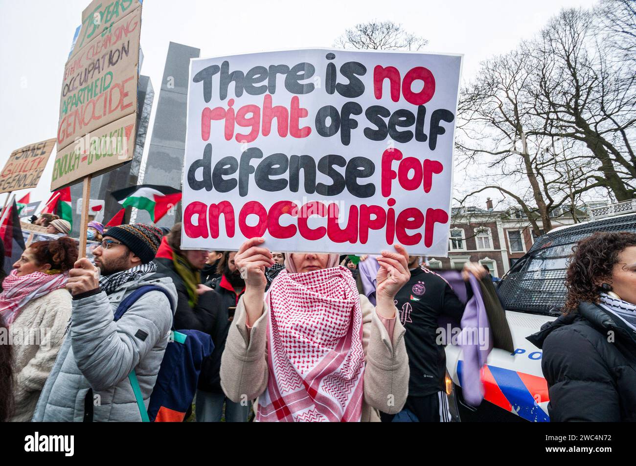 Un manifestante tiene cartelli che esprimono la sua opinione, durante l'audizione della Corte internazionale di giustizia (ICJ). Centinaia di sostenitori pro-palestinesi e alcuni pro-israeliani sono stati tenuti ben separati oggi, al di fuori della Corte internazionale di giustizia (ICJ) o del Palazzo della Pace dell'Aia, il secondo giorno dell'udienza. Il Sudafrica ha accusato Israele di genocidio nei confronti del popolo palestinese. Oggi, gli israeliani hanno avuto la possibilità di difendersi in tribunale e hanno respinto con veemenza le accuse come "infondate” e antisemite. A Gaza, più di 23.800 persone - per lo più donne e bambini lo hanno fatto Foto Stock