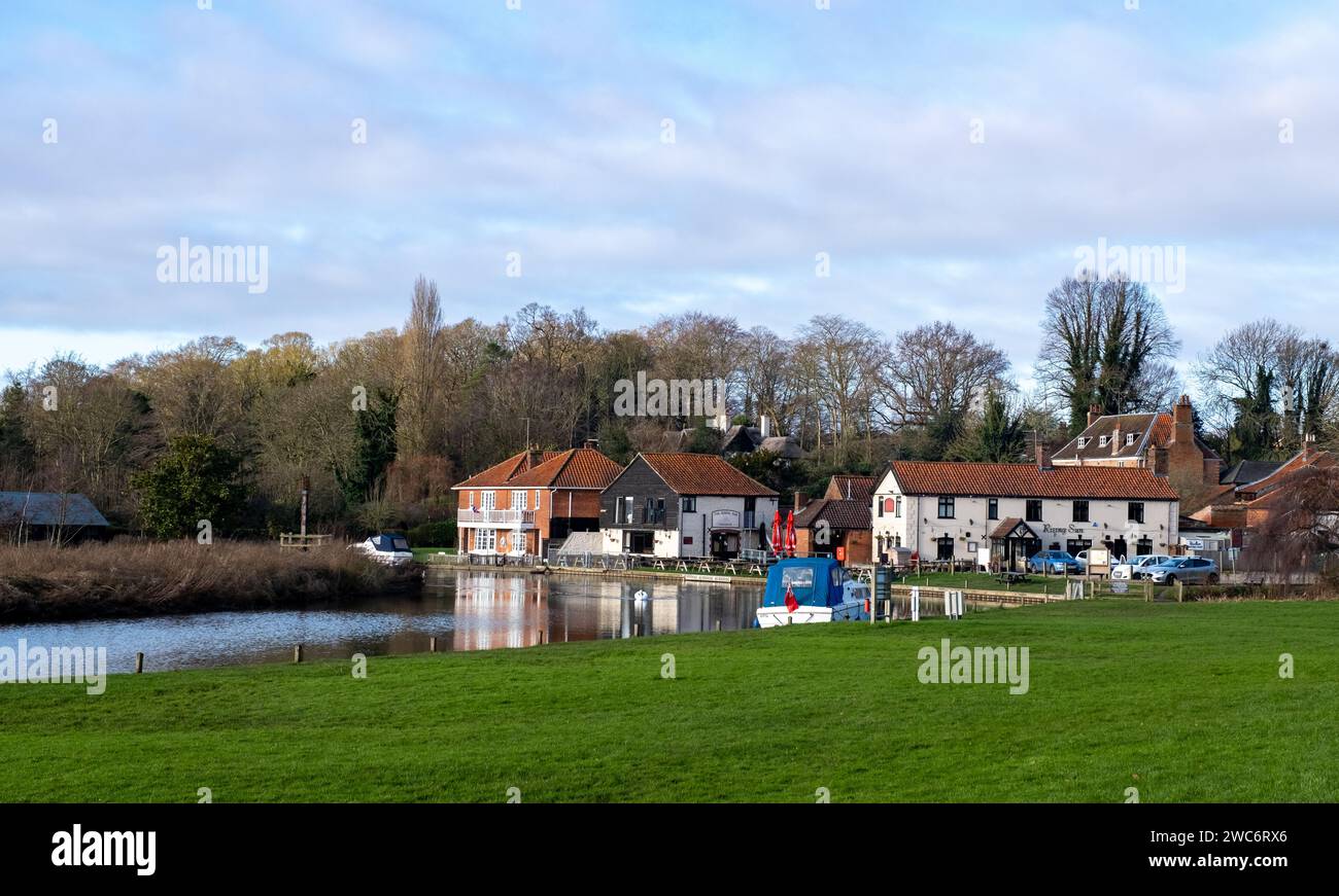 Coltishall, Norfolk, Regno Unito – 13 gennaio 2024. Vista sul verde del villaggio verso il ristorante e pub Rising Sun sulla riva del fiume Bure Foto Stock