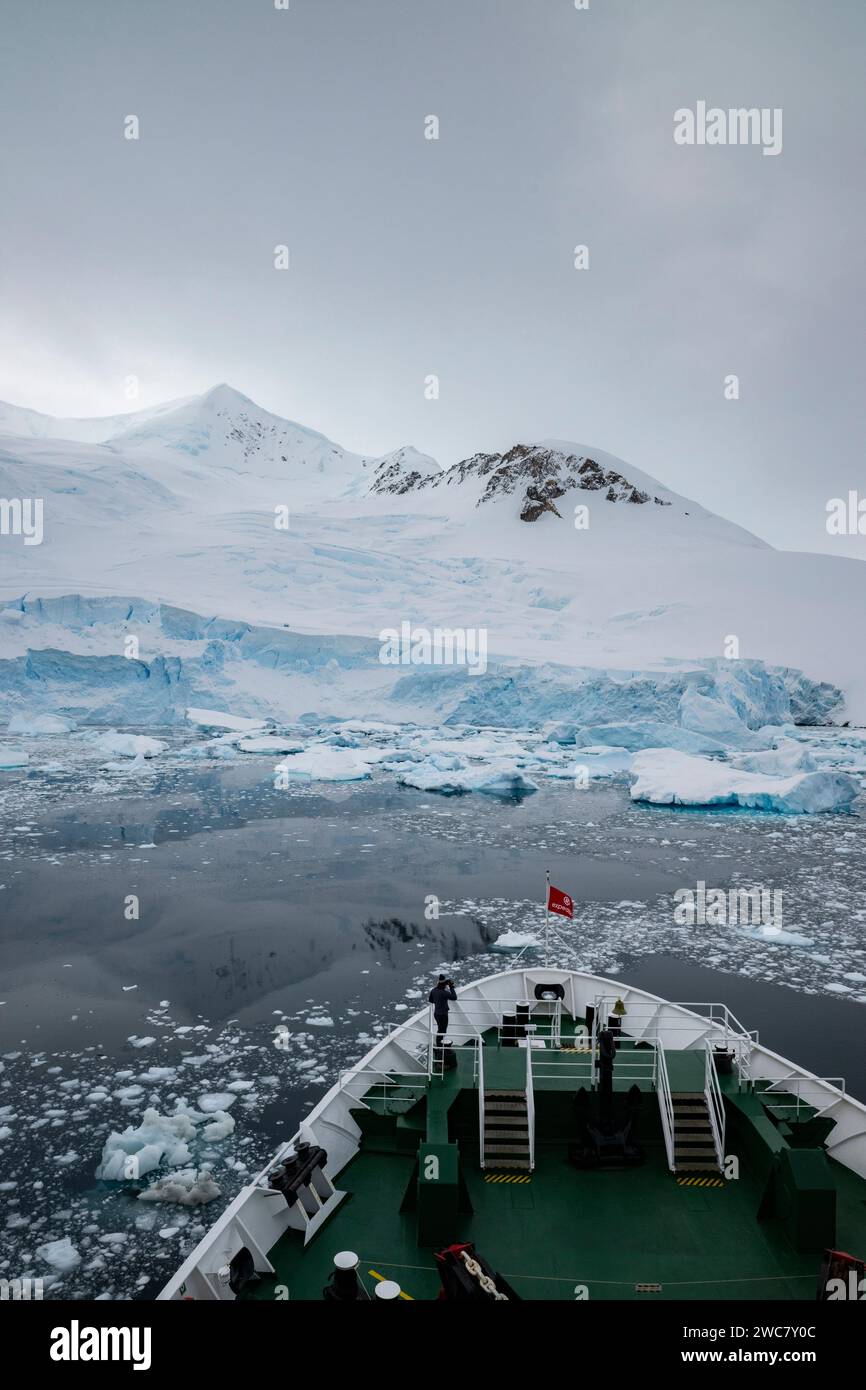 Neko Harbor, Antartide, vista del porto e della costa, nave da spedizione che naviga attraverso acque piene di ghiaccio, mostrando prua di nave e previsioni Foto Stock