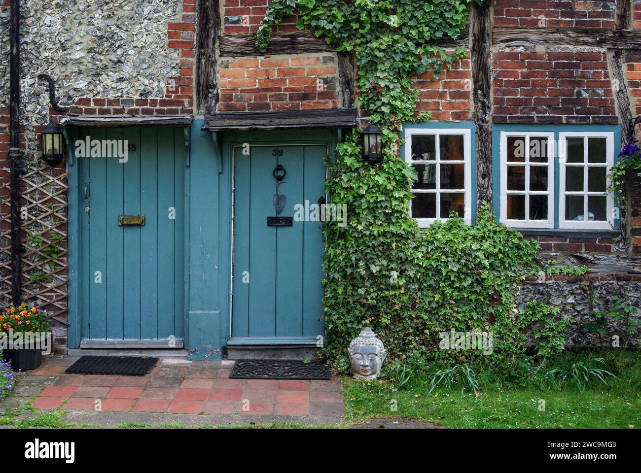 Porte d'ingresso blu adiacenti su vecchi cottage in pietra, Crown Court, West Wycombe, Buckinghamshire, Regno Unito Foto Stock