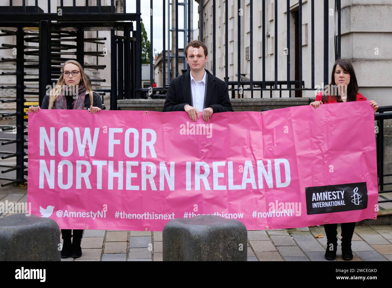 Attivista pro Choice che tiene striscioni con la scritta «Now for Northern Ireland» al di fuori delle corti reali di giustizia di Belfast Foto Stock