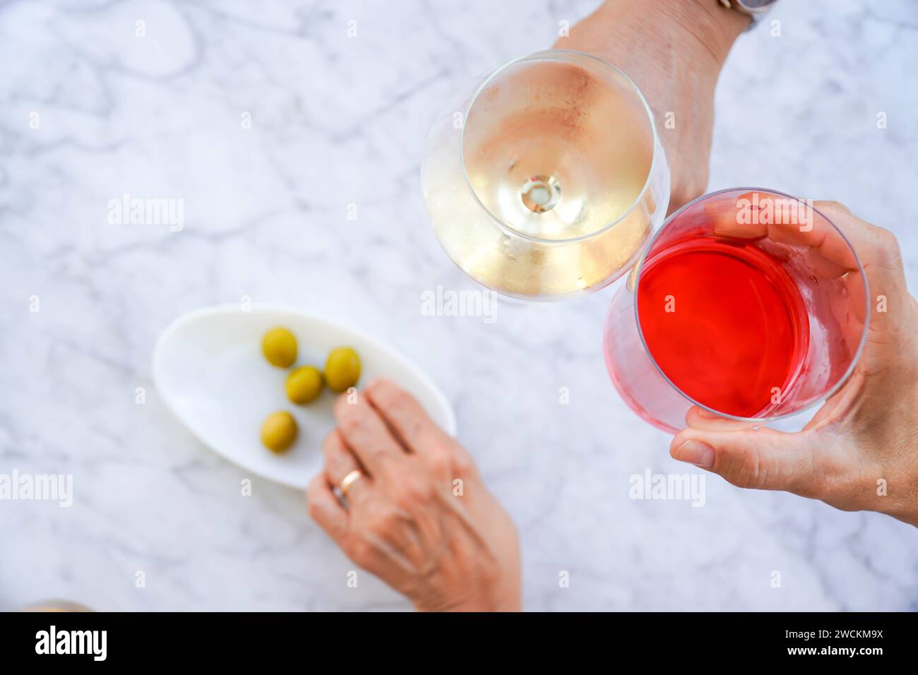 Gruppo di amici irriconoscibili che bevono un drink e trascorrono la giornata all'aperto in terrazza Foto Stock