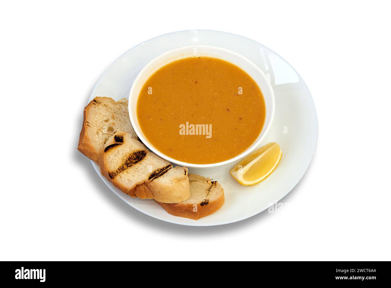 Gustosa ciotola di lenticchie su piatto con limone e pane isolato su sfondo bianco Foto Stock