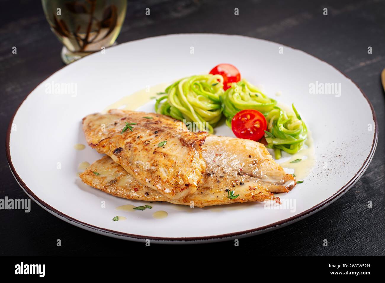 Filetto di pesce alla griglia con pasta di zucchine. Concetto di cibo sano. Foto Stock