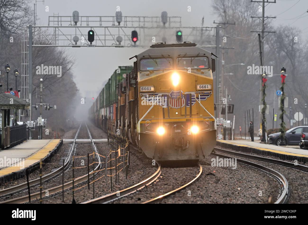 Glen Ellyn, Illinois, USA. In un giorno nebbioso, un paio di giorni prima di Natale, più locomotive guidano un treno merci Union Pacific. Foto Stock