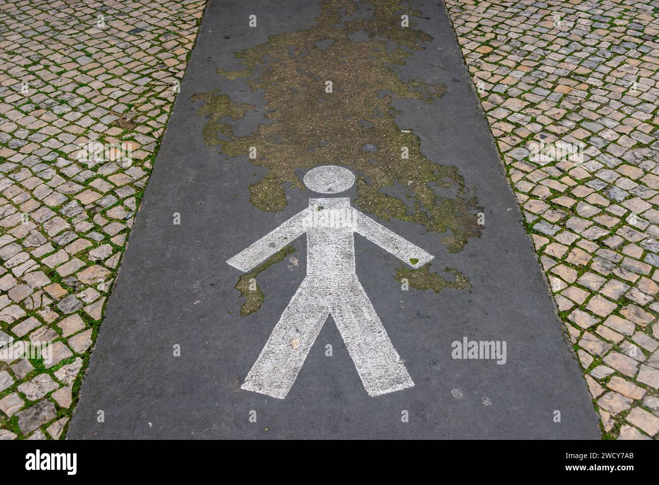 Figura dipinta che mostra il percorso pedonale su una strada acciottolata Foto Stock
