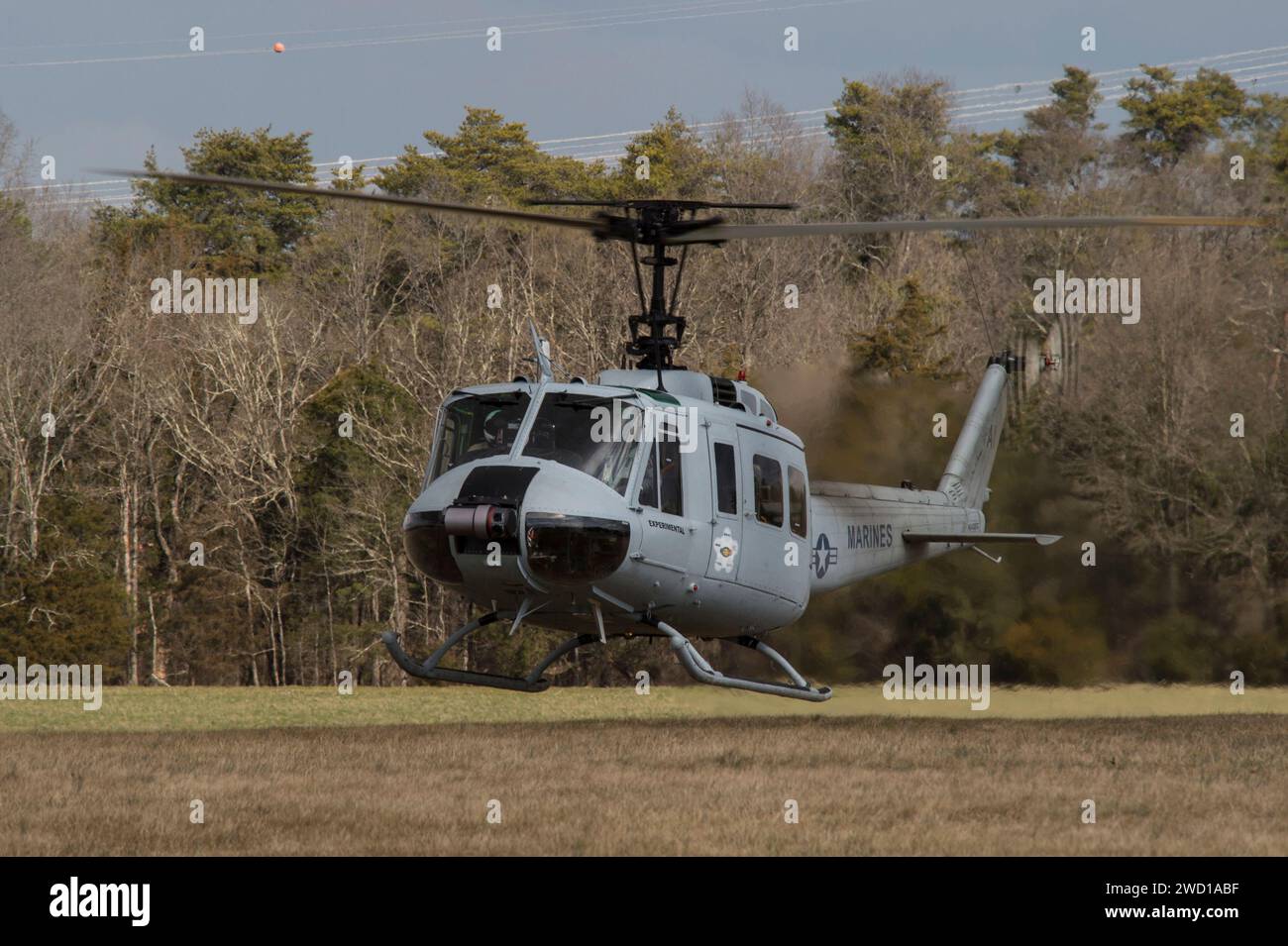 Un Huey UH-1 dotato di un sistema cargo/utility aereo autonomo, arriva per l'atterraggio. Foto Stock