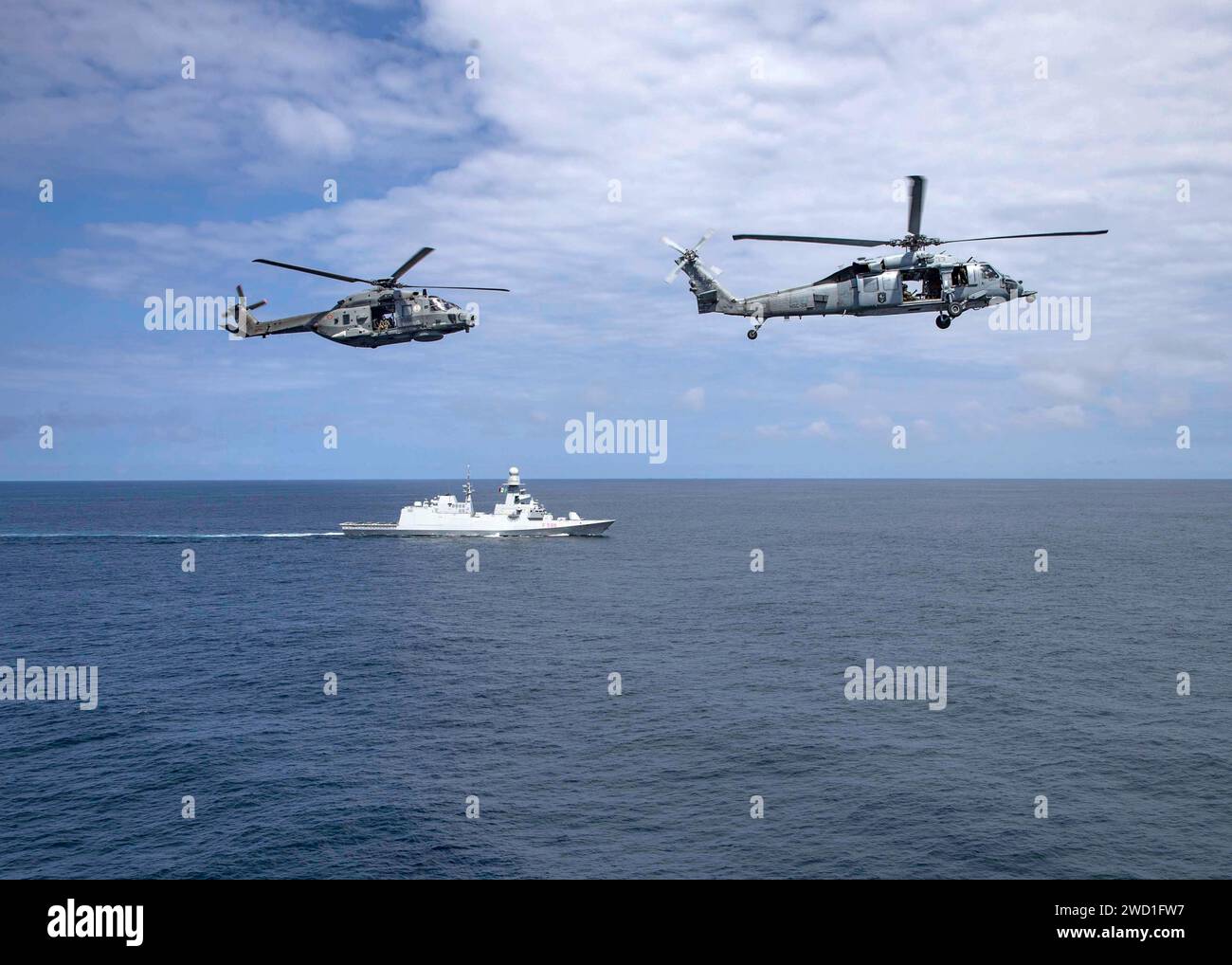 Un MH-60S Seahawk della US Navy e un elicottero italiano NH 90 eseguono un sorvolo sulla fregata DELLA Marina italiana LA SUA Federico Martinengo. Foto Stock