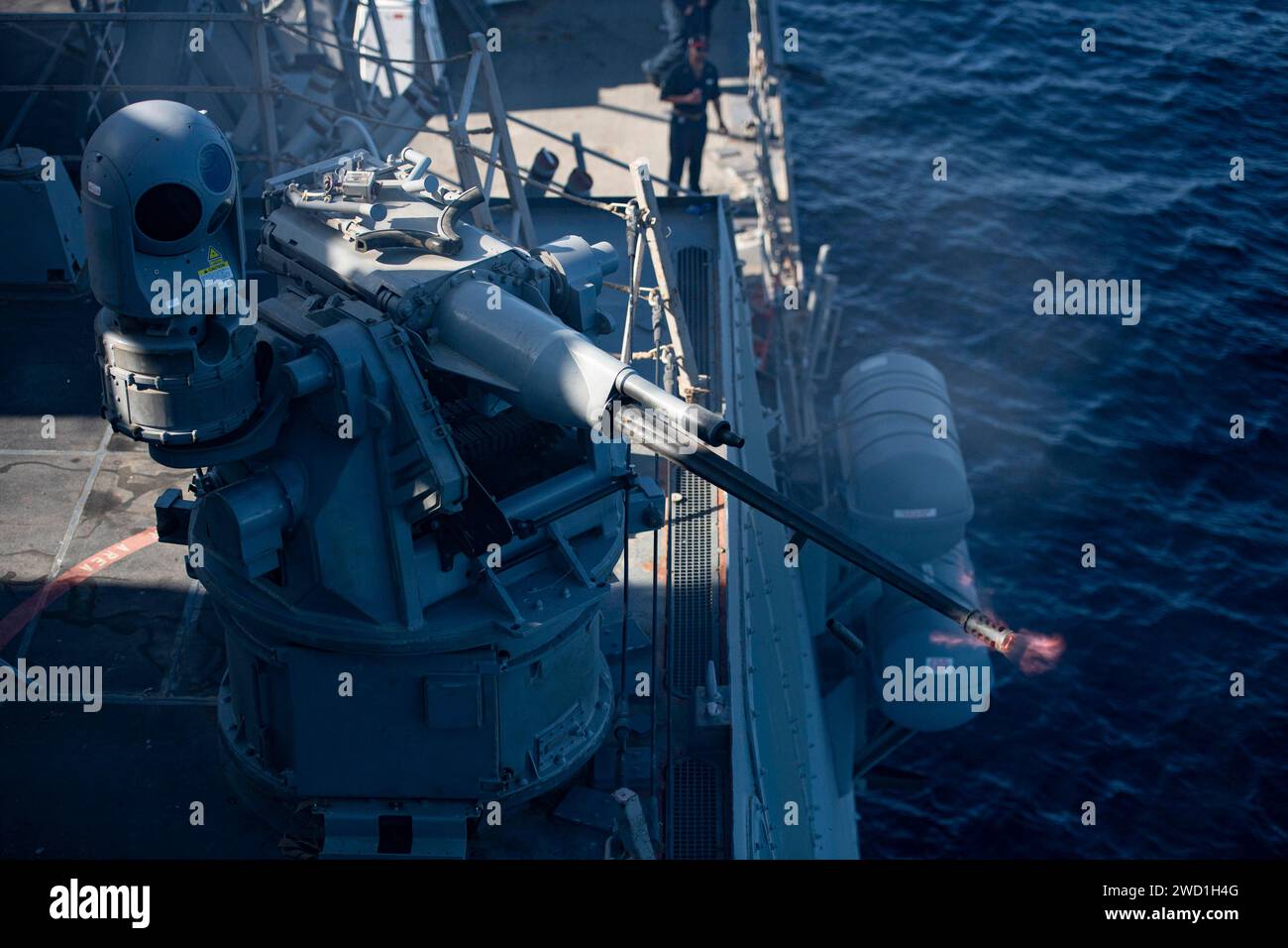 Il cacciatorpediniere USS Sterett spara il suo cannone da 25 mm durante un'esercitazione di fuoco nel Golfo dell'Oman. Foto Stock