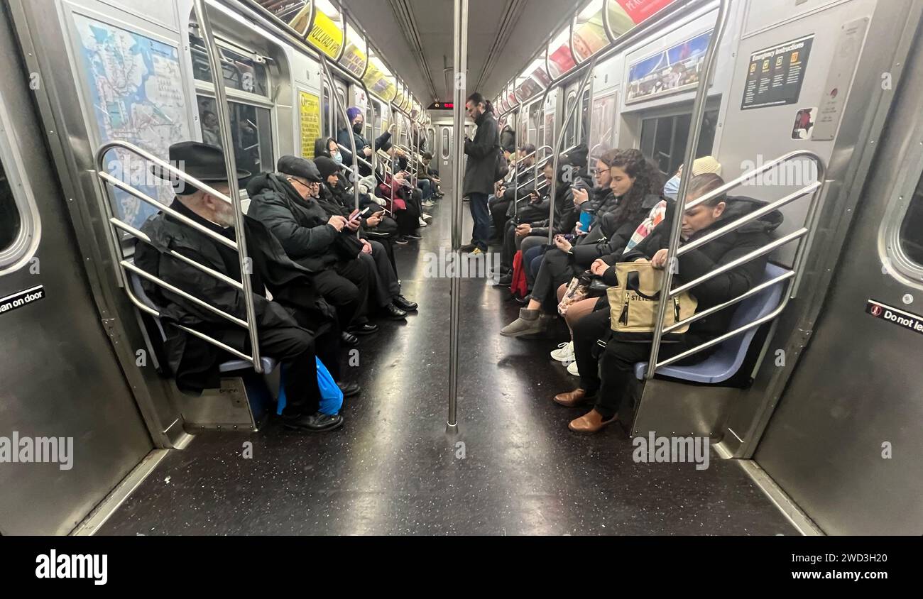 Persone che viaggiano a Manhattan da Brooklyn la mattina su un treno F. Foto Stock