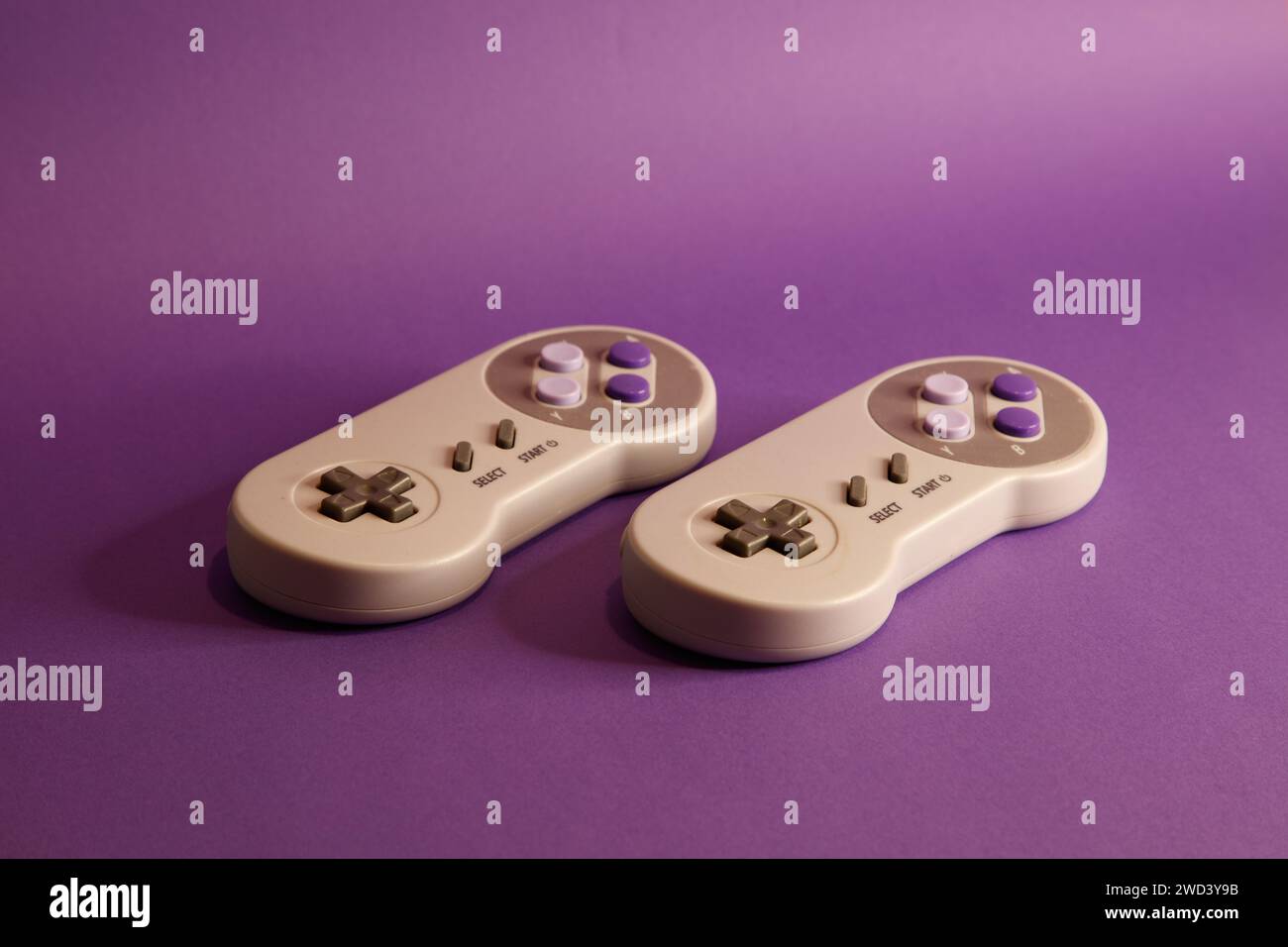 Console per videogiochi di tipo Nintendo su sfondo mouve, fotografia in studio Foto Stock