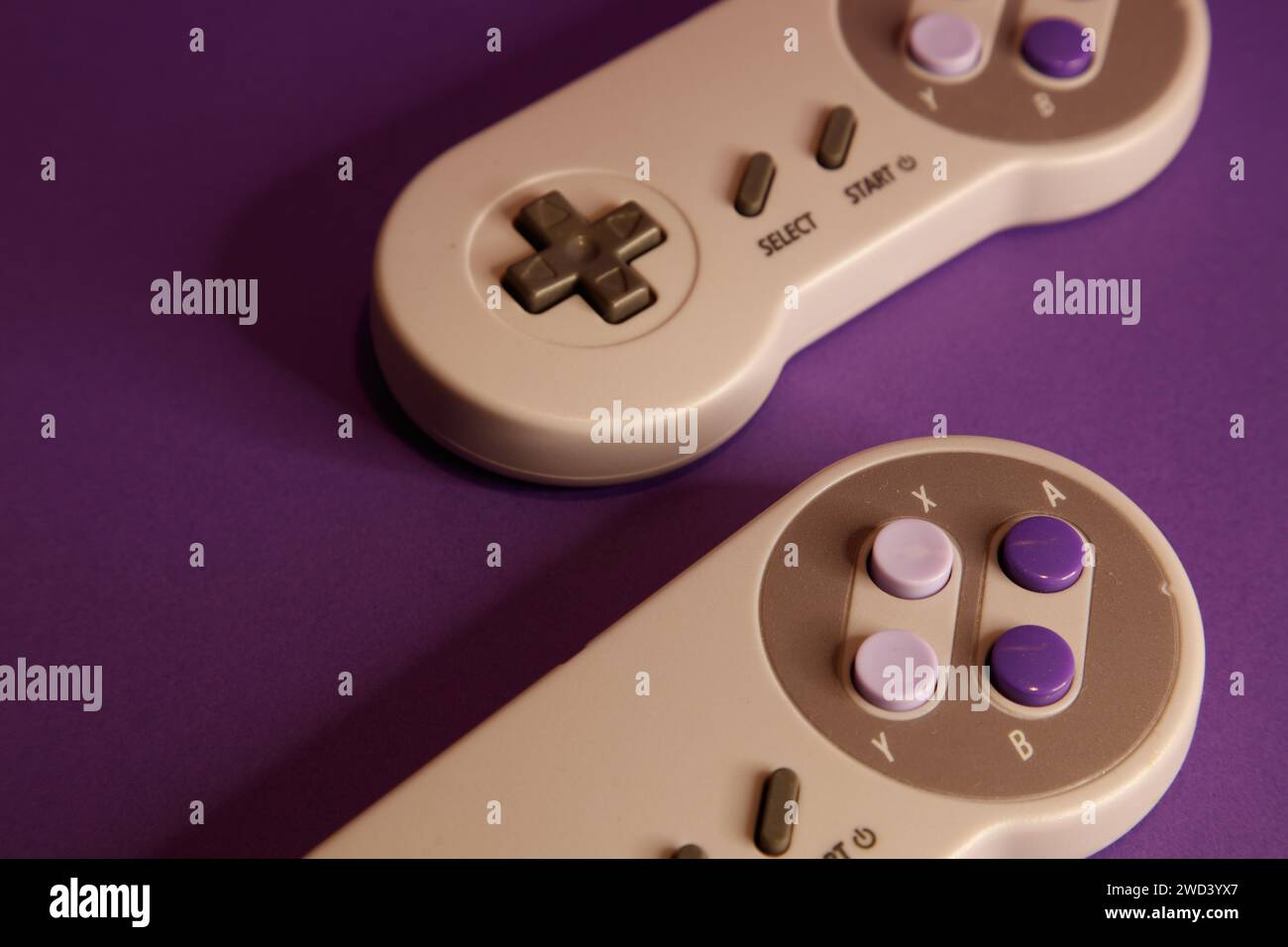 Console per videogiochi di tipo Nintendo su sfondo mouve, fotografia in studio Foto Stock