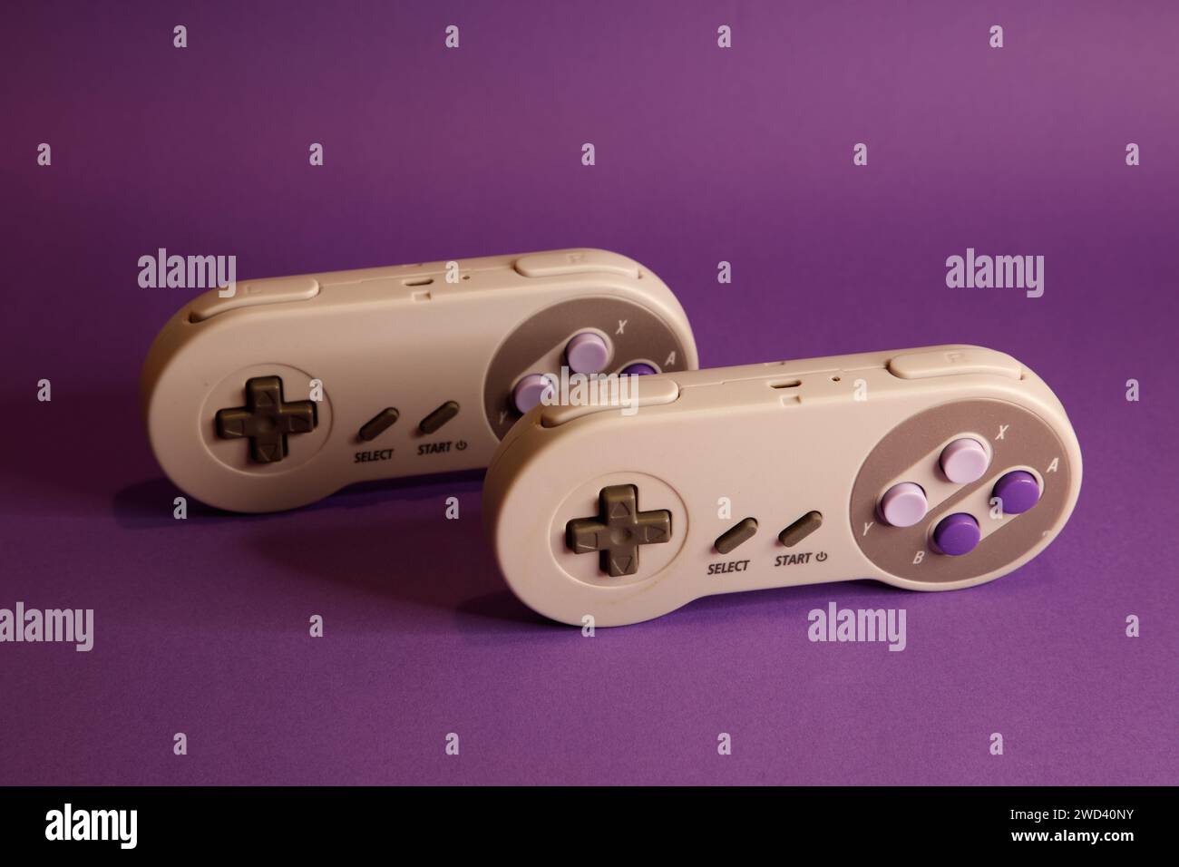 Console per videogiochi di tipo Nintendo su sfondo mouve, fotografia in studio Foto Stock