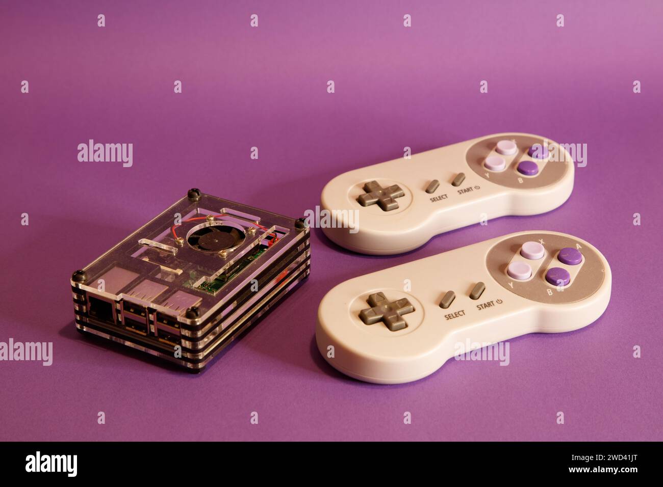 Console per videogiochi di tipo Nintendo e un computer Raspberry Pie, su sfondo con mouse, fotografia in studio Foto Stock