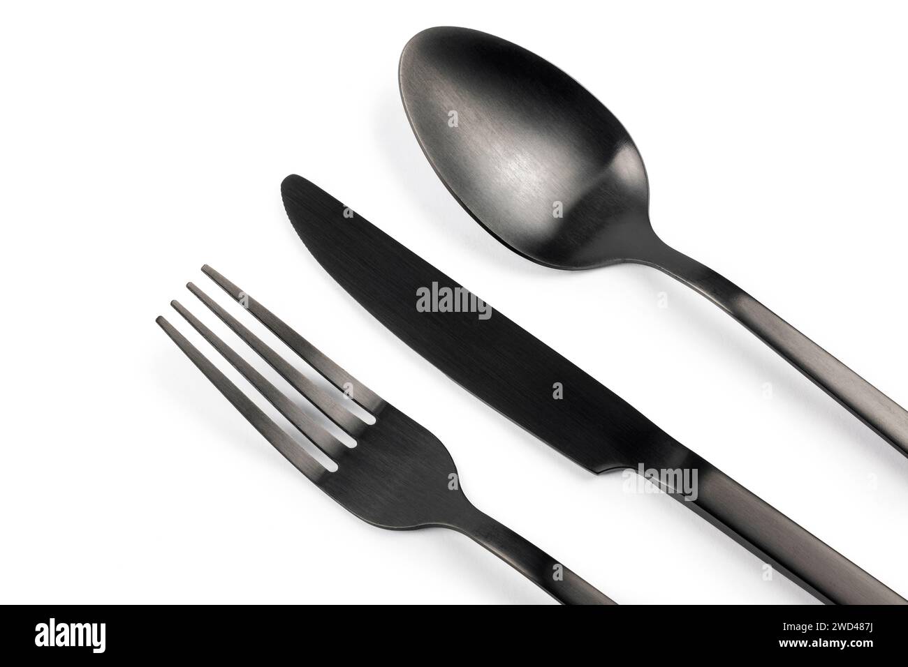 Set argenteria nera. Forchetta, coltello e cucchiaio su sfondo bianco Foto Stock