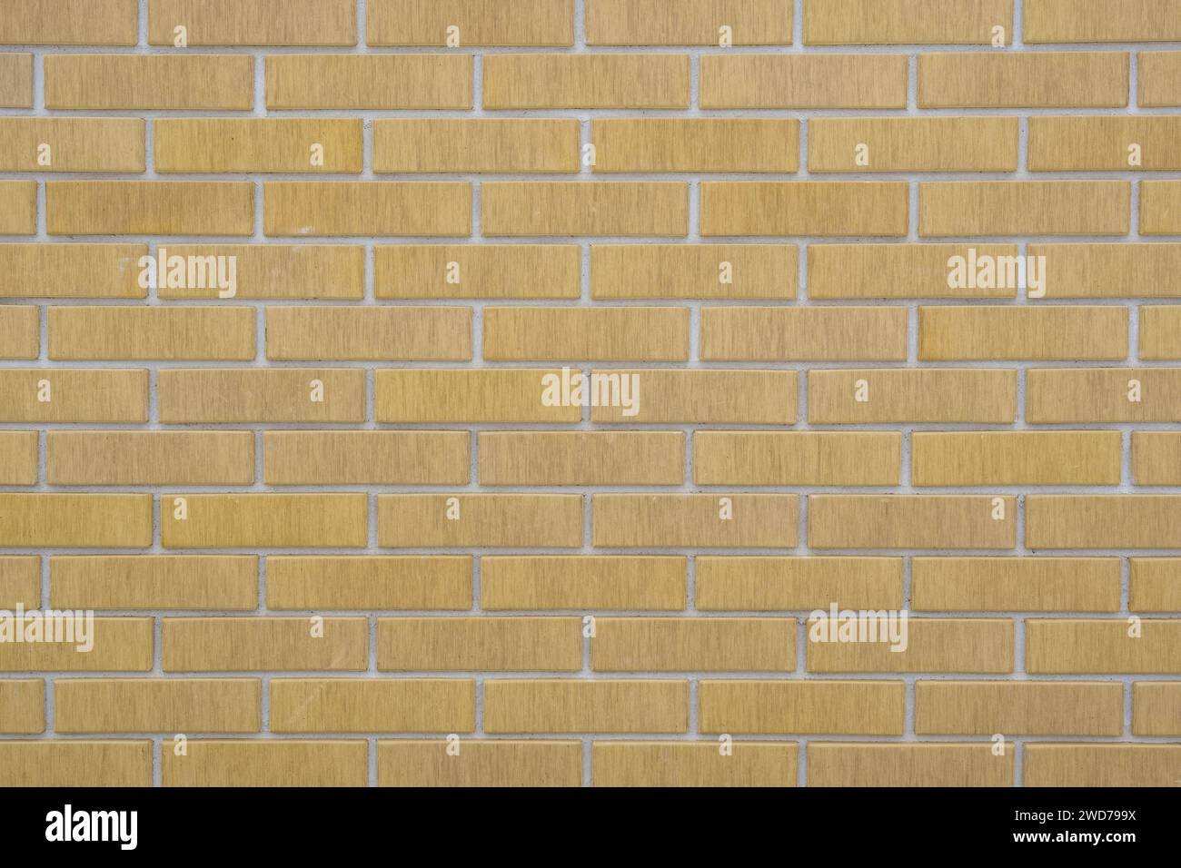 Un primo piano di un muro di mattoni gialli testurizzati Foto Stock