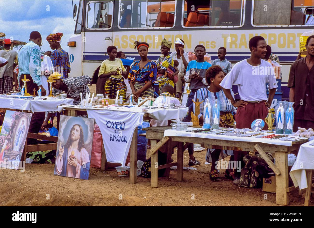 Costa d'Avorio, Yamoussoukro; persone che vendono icone cristiane, candele e dipinti al parcheggio della cattedrale di Notre Dame de la Paix. Foto Stock